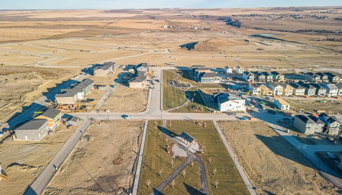 Aerial overview of community, Glacier Ridge in Northwest Calgary showhome construction and a community park.