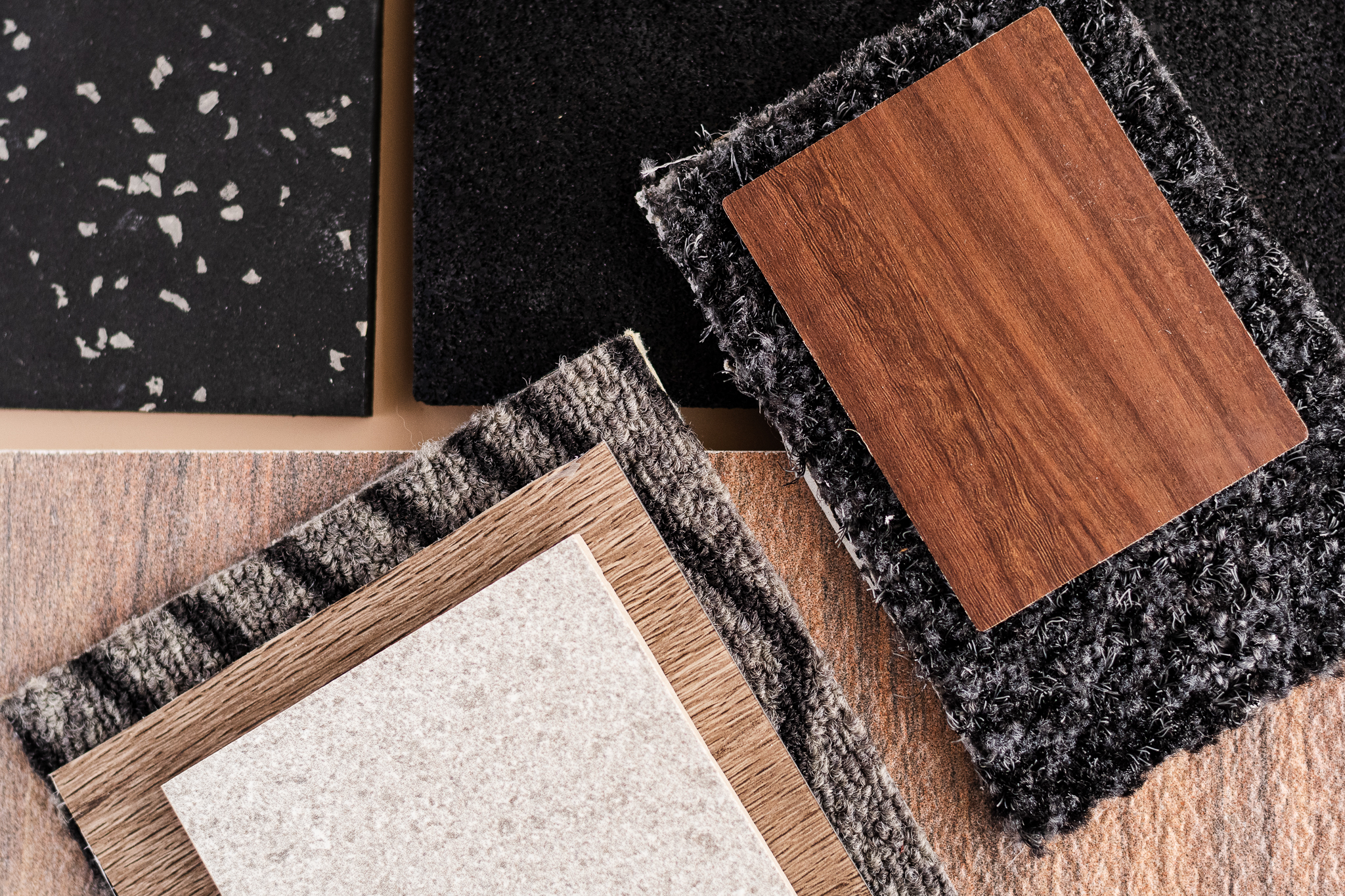 Material samples of wood, tile and carpet.